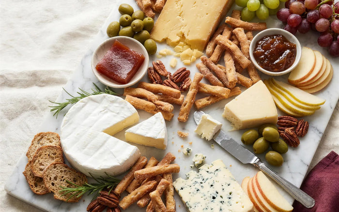 Discover hub card — Cheese & Kurma: cheese board with golden Kurma woven among the cheeses
